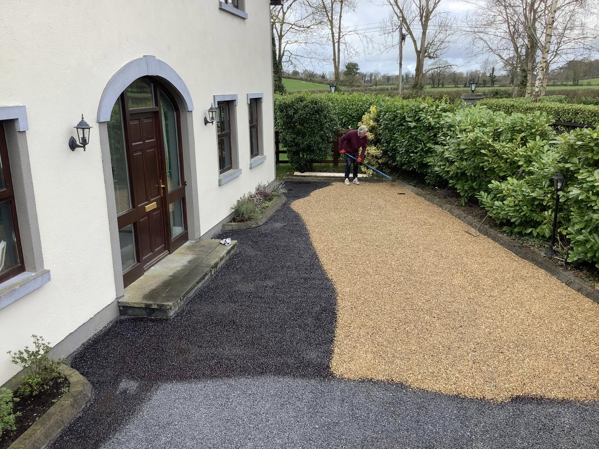 tar and chip being applied to a driveway