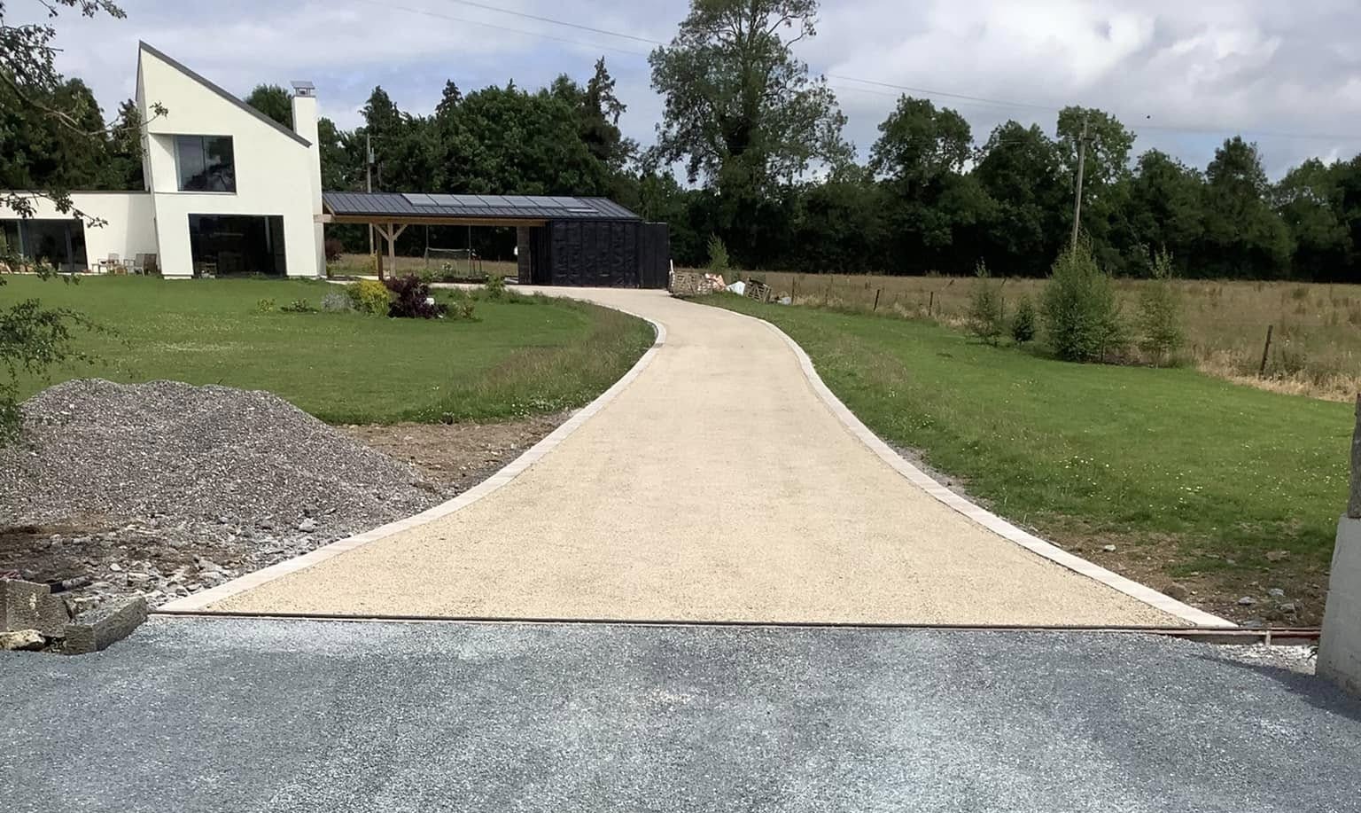 Newly laid tar and chip driveway with gold coloured stone chip