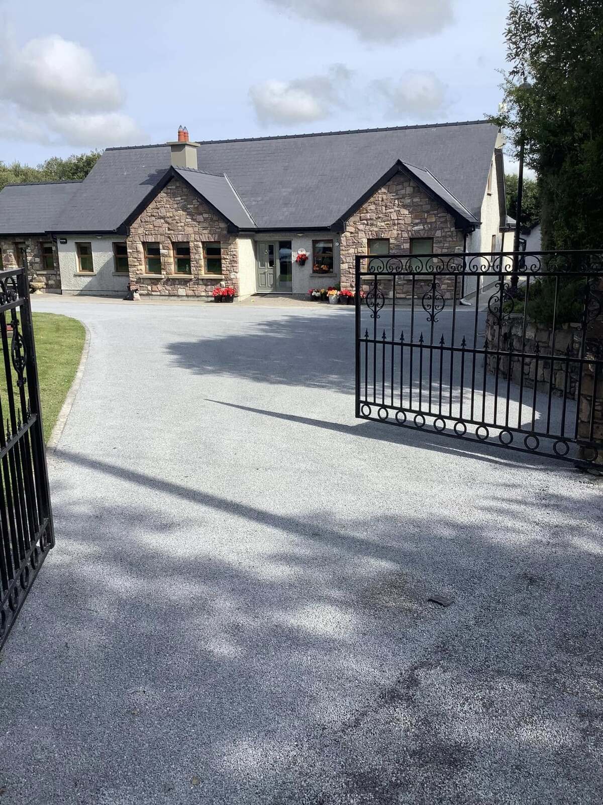 grey coloured tar and chip driveway installation at front of house