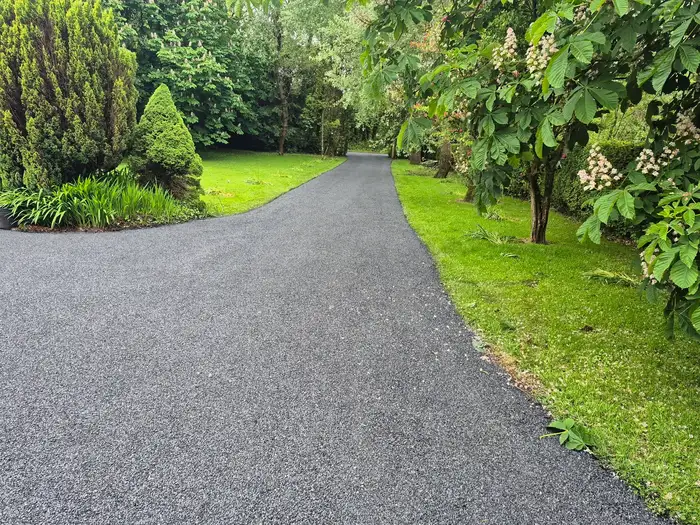 tar and chip driveway installation at the front of a house