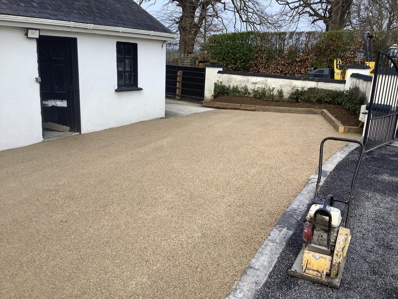A tar and chip driveway being cleaned