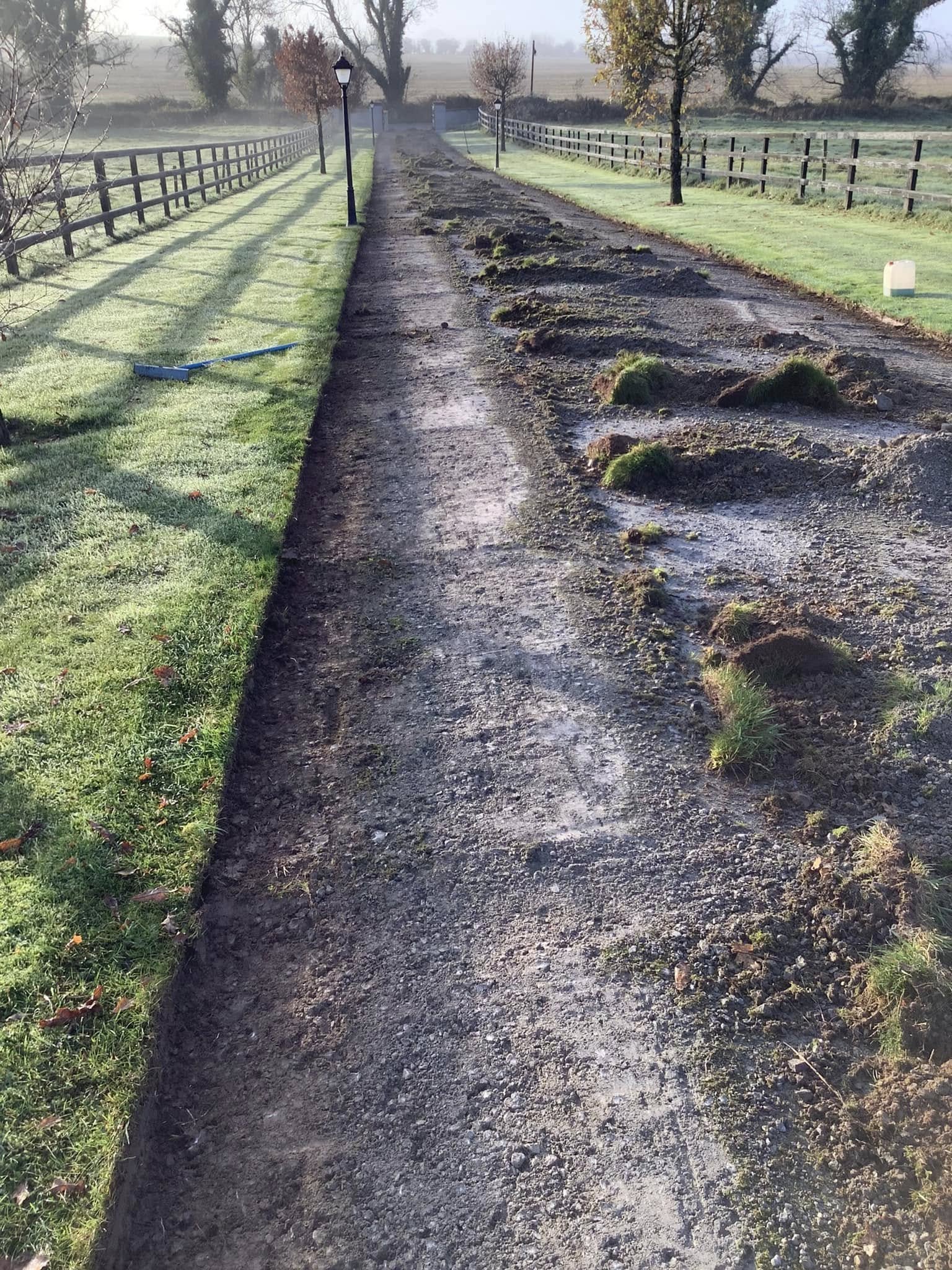 driveway surface being cleared of old gravel and grass